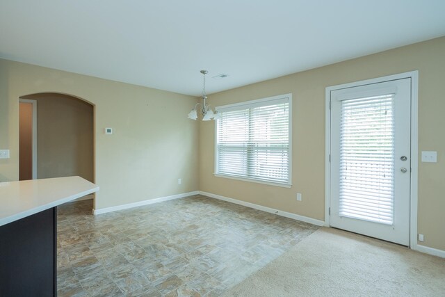 173 Tiara Rdg, Duncan, SC 29334 - unfurnished dining area featuring a chandelier, baseboards, and arched walkways