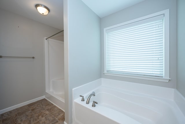 173 Tiara Rdg, Duncan, SC 29334 - bathroom featuring a bath, a shower, and baseboards