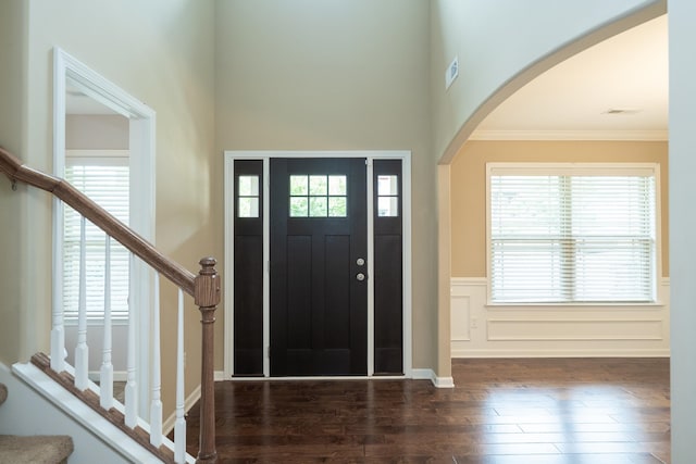 173 Tiara Rdg, Duncan, SC 29334 - entrance foyer featuring arched walkways, wood finished floors, ornamental molding, a wainscoted wall, and stairway