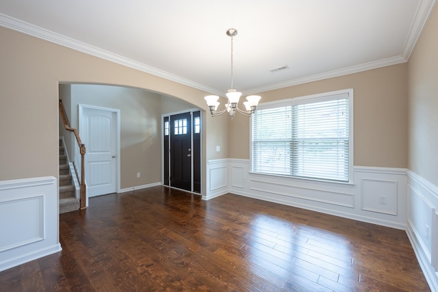 173 Tiara Rdg, Duncan, SC 29334 - unfurnished dining area featuring a chandelier, healthy amount of natural light, arched walkways, a wainscoted wall, and crown molding