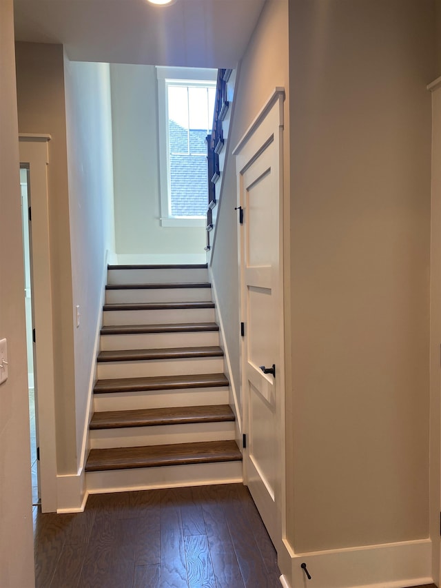 stairs featuring baseboards and wood-type flooring