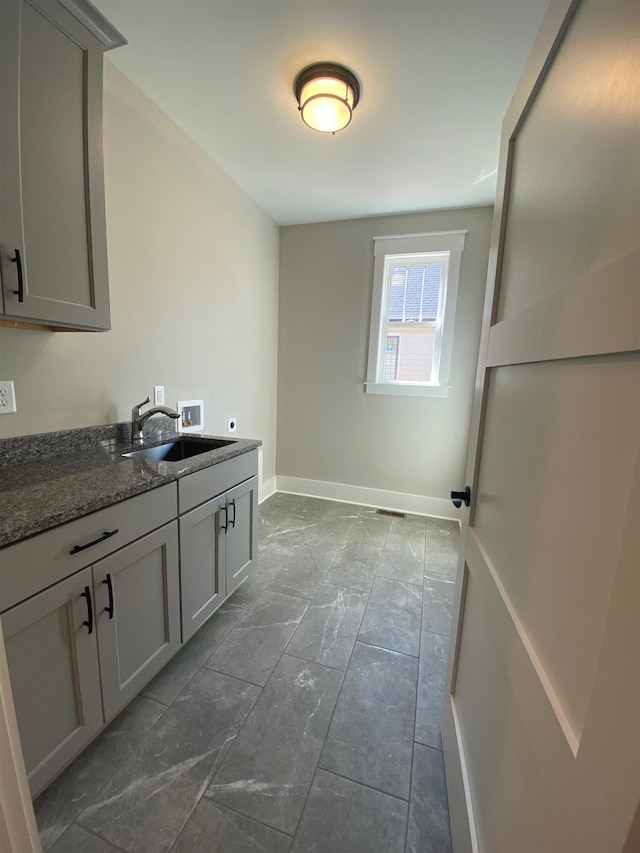 laundry area featuring hookup for a washing machine, electric dryer hookup, cabinet space, and baseboards