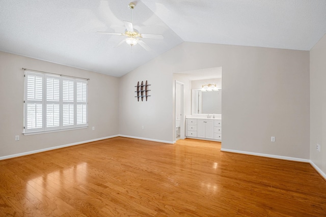 2 Birch Tree, Greer, SC 29651 - unfurnished bedroom featuring lofted ceiling, light wood finished floors, baseboards, a sink, and connected bathroom