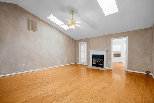 2 Birch Tree, Greer, SC 29651 - unfurnished living room featuring a skylight, wood finished floors, a ceiling fan, a fireplace with flush hearth, and high vaulted ceiling