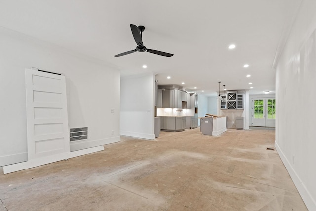 unfurnished living room featuring a ceiling fan, recessed lighting, baseboards, unfinished concrete flooring, and ornamental molding