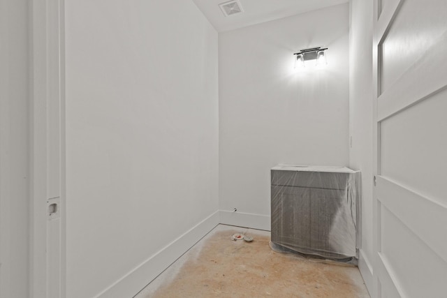 detailed view of baseboards and unfinished concrete flooring