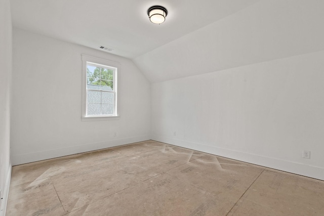 bonus room featuring baseboards and lofted ceiling