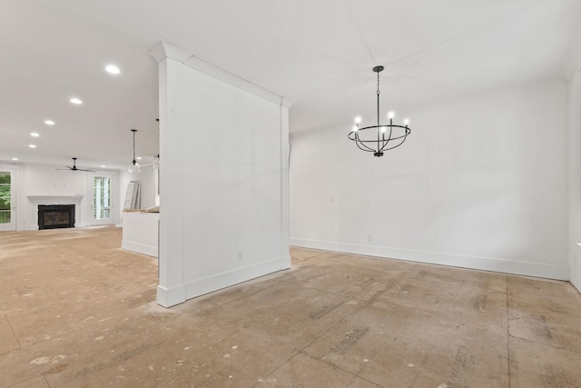 unfurnished dining area featuring a fireplace, baseboards, a chandelier, recessed lighting, and ceiling fan