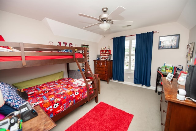 bedroom featuring vaulted ceiling, light carpet, and a ceiling fan