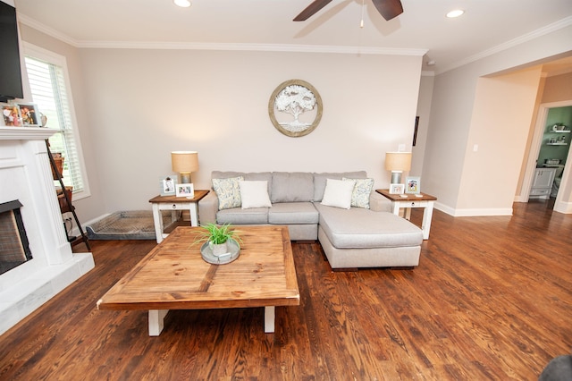 living room featuring wood finished floors, a ceiling fan, a fireplace with raised hearth, recessed lighting, and baseboards