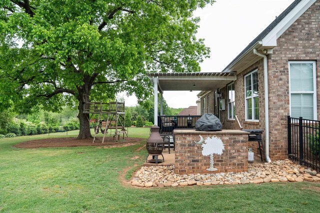 view of green lawn featuring a patio area