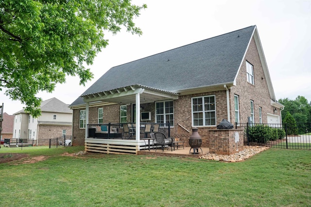 back of house with brick siding, a deck, roof with shingles, and a patio area