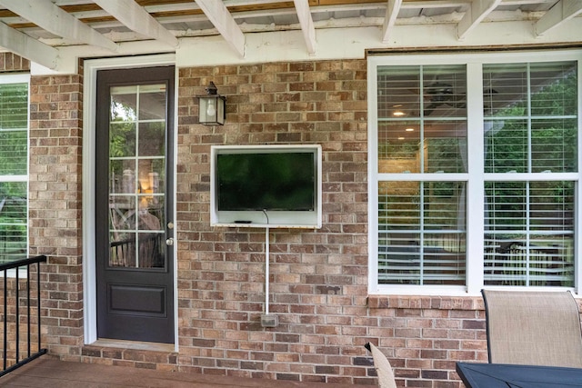 view of exterior entry with brick siding