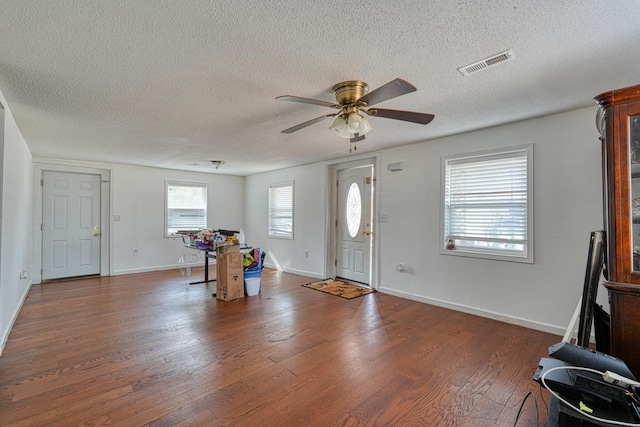 foyer with a textured ceiling, a ceiling fan, wood finished floors, and baseboards