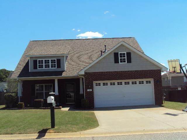 474 Slate, Boiling Springs, SC 29316 - view of front facade with concrete driveway, a front yard, an attached garage, and brick siding