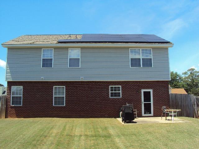 474 Slate, Boiling Springs, SC 29316 - back of property with roof mounted solar panels, brick siding, and a patio