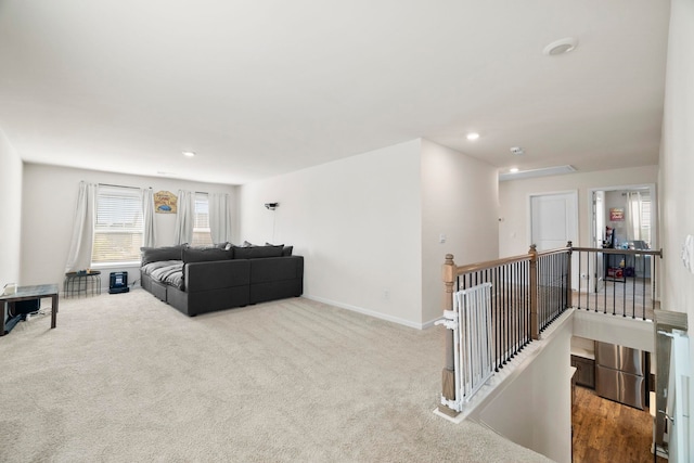 living room with recessed lighting, carpet floors, and baseboards
