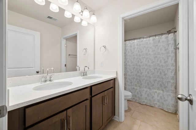 full bath featuring toilet, double vanity, tile patterned floors, and curtained shower