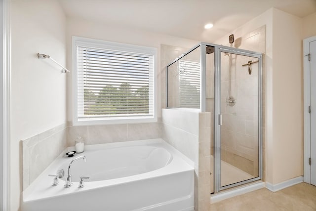 bathroom with a shower stall and a bath