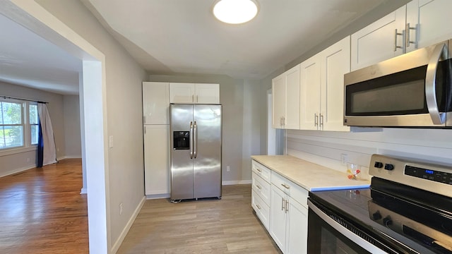 203 N Evans, Union, SC 29379 - kitchen featuring stainless steel appliances, light wood-type flooring, and white cabinetry