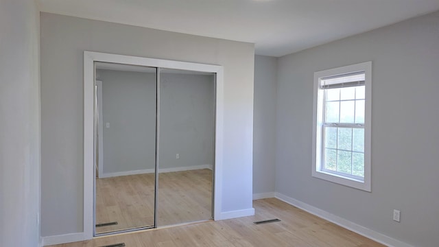 203 N Evans, Union, SC 29379 - unfurnished bedroom with multiple windows, light wood-style floors, baseboards, and a closet