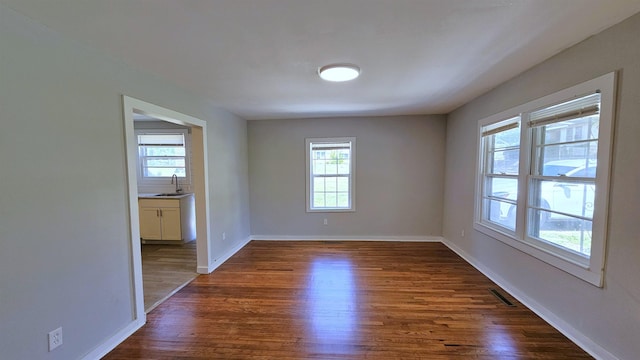 203 N Evans, Union, SC 29379 - unfurnished room featuring dark wood-type flooring, baseboards, and a sink