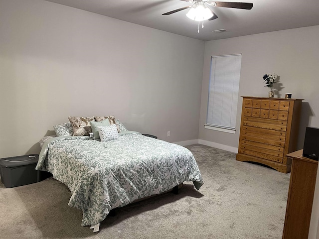 carpeted bedroom with a ceiling fan and baseboards