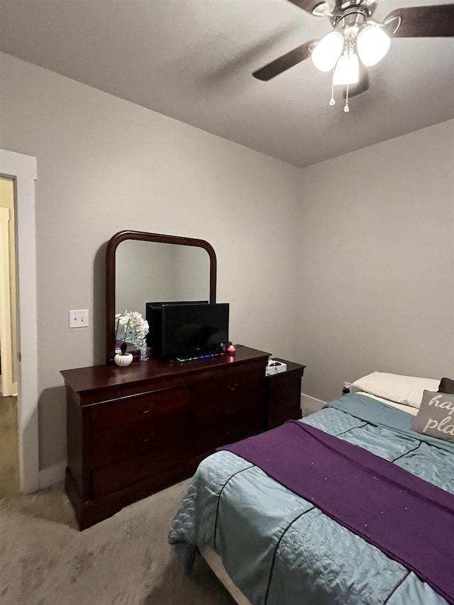 carpeted bedroom with baseboards and ceiling fan