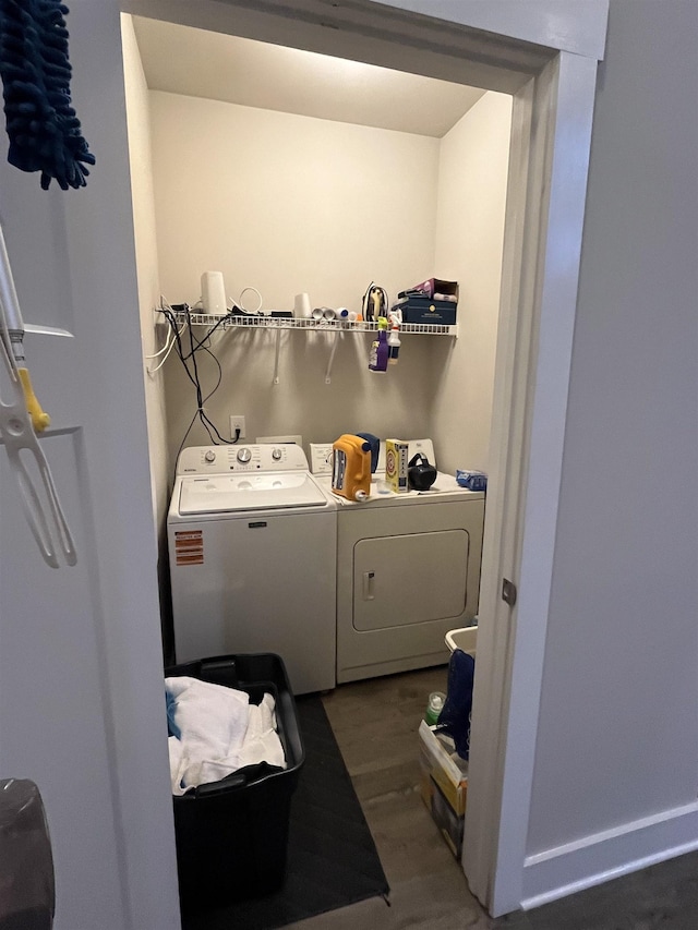 laundry area with separate washer and dryer and wood finished floors