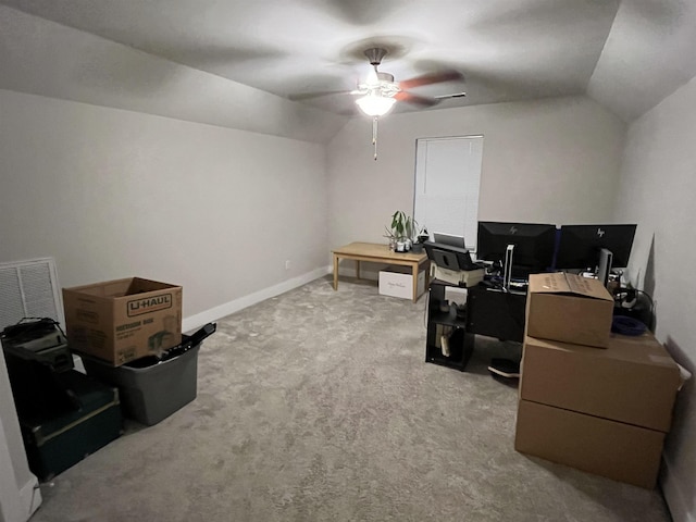 office area featuring vaulted ceiling, a ceiling fan, light carpet, and baseboards
