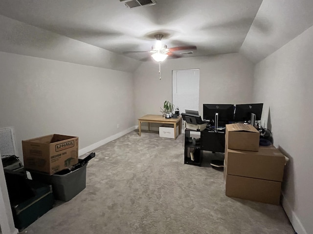 home office featuring vaulted ceiling, light colored carpet, a ceiling fan, and baseboards