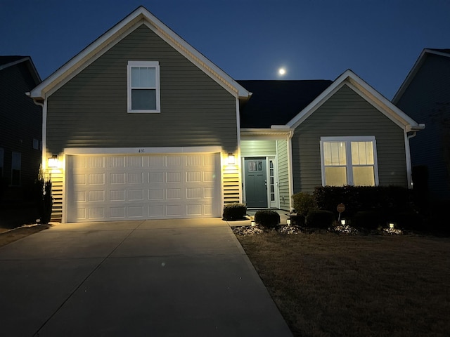traditional-style home featuring concrete driveway and a garage