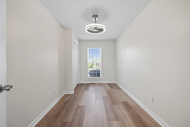 empty room with wood finished floors and baseboards