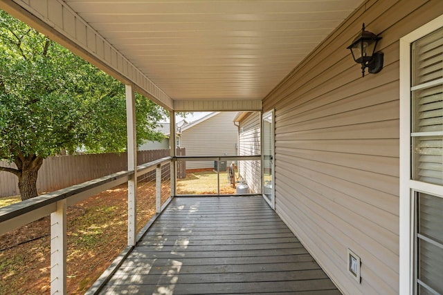 wooden terrace featuring fence