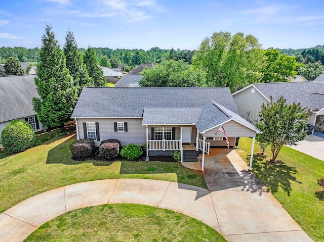 view of front facade featuring driveway, a front yard, covered porch, roof with shingles, and a carport