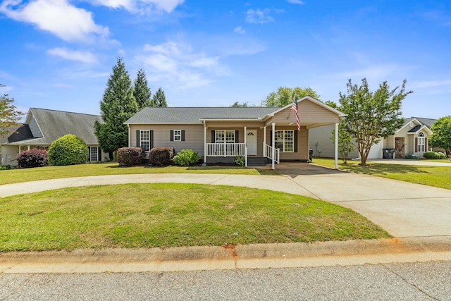 single story home with curved driveway, a porch, a front yard, and an attached carport