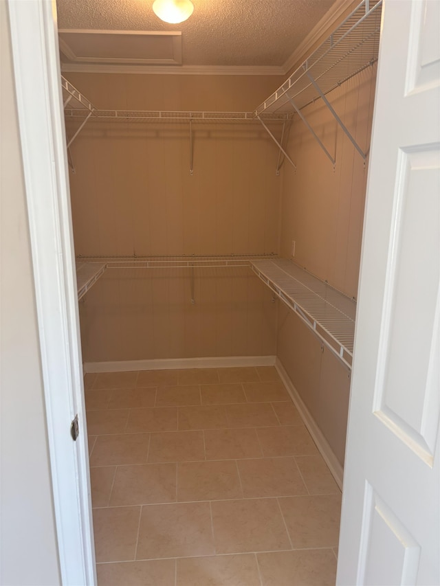 spacious closet featuring light tile patterned floors