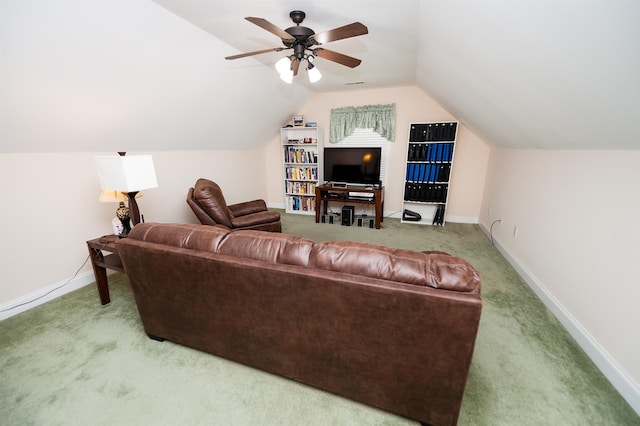 carpeted living area featuring vaulted ceiling, baseboards, and a ceiling fan