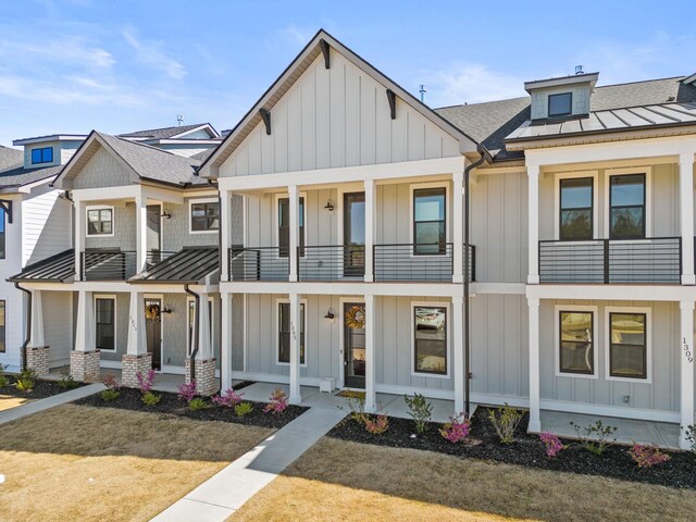 1305 S Pinot, Duncan, SC 29334 - view of front facade featuring board and batten siding, a balcony, a standing seam roof, and a porch