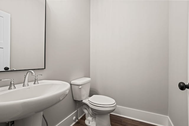 1208 N Pinot, Duncan, SC 20334 - bathroom with baseboards, a sink, wood finished floors, and toilet