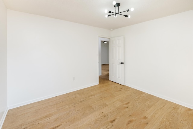 2 Willowood, Spartanburg, SC 29303 - unfurnished room featuring a chandelier, baseboards, and wood finished floors