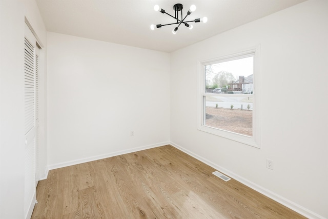 2 Willowood, Spartanburg, SC 29303 - unfurnished room with a chandelier, light wood-style floors, and baseboards