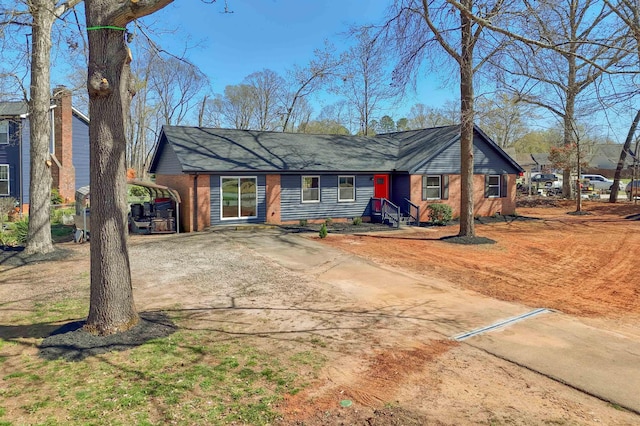 2 Willowood, Spartanburg, SC 29303 - view of front of house featuring brick siding, a detached carport, and dirt driveway