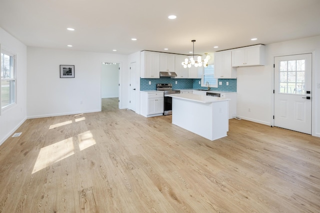 2 Willowood, Spartanburg, SC 29303 - kitchen with electric stove, a sink, a kitchen island, light countertops, and white cabinetry