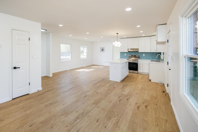 2 Willowood, Spartanburg, SC 29303 - kitchen with stainless steel range with electric stovetop, under cabinet range hood, a center island, light countertops, and backsplash