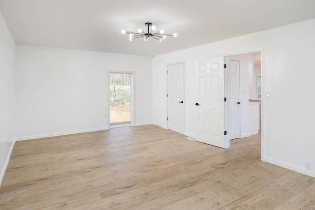 2 Willowood, Spartanburg, SC 29303 - unfurnished room featuring a chandelier, light wood-style flooring, and baseboards