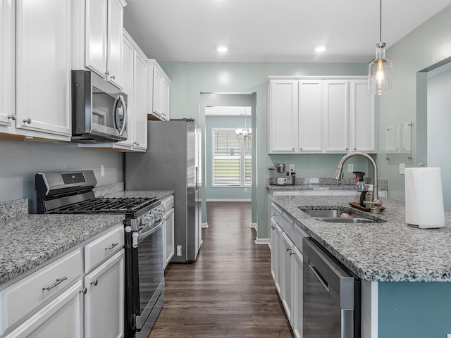 kitchen featuring stainless steel appliances, a sink, dark wood finished floors, white cabinets, and recessed lighting