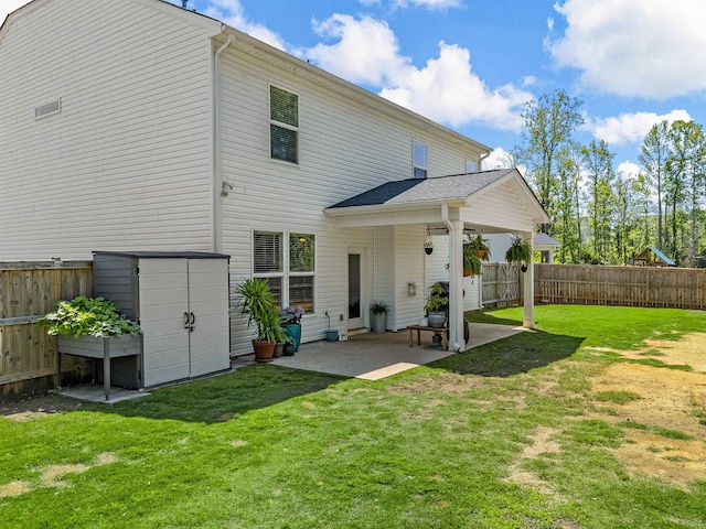 back of house with a patio, a shed, an outdoor structure, and a playground