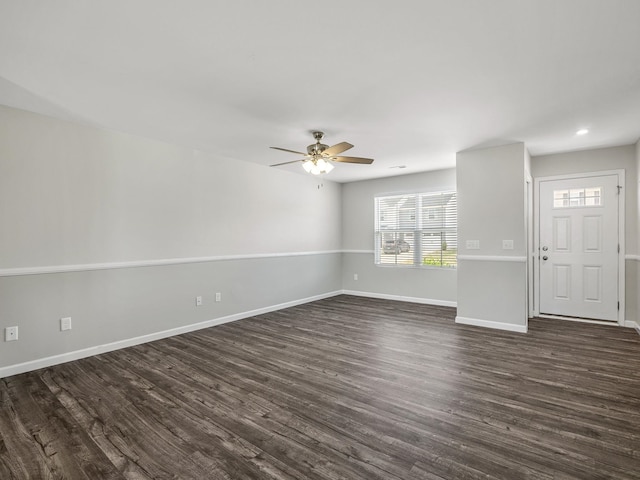 unfurnished living room with dark wood-style floors, baseboards, a ceiling fan, and recessed lighting