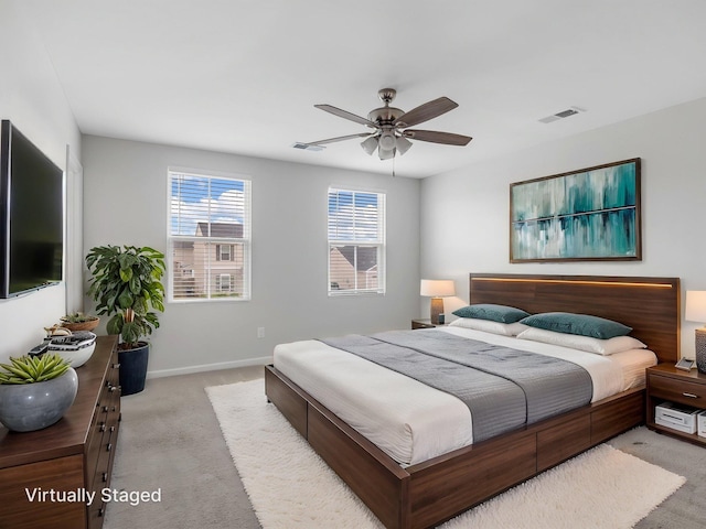 bedroom featuring light carpet, baseboards, and ceiling fan